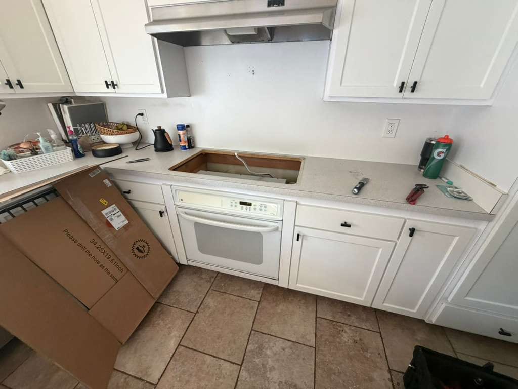 Countertop opening prepared beside a new Empava cooktop carton in Fullerton