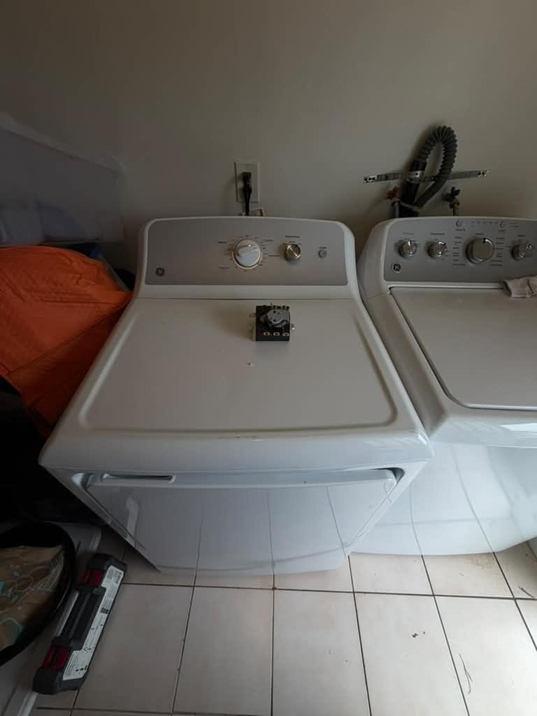 White GE dryer beside a washer in a Costa Mesa laundry room