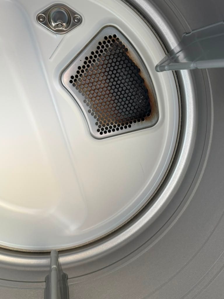 Heat scorching around the rear exhaust grille inside an LG dryer drum in Santa Ana