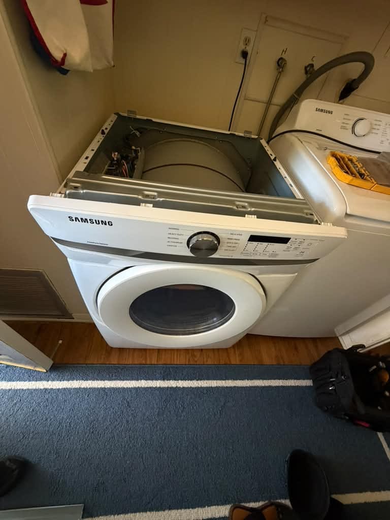 Samsung front-load dryer with its top service panel open for a control-board repair, beside a Samsung top-load washer in a San Juan Capistrano laundry room