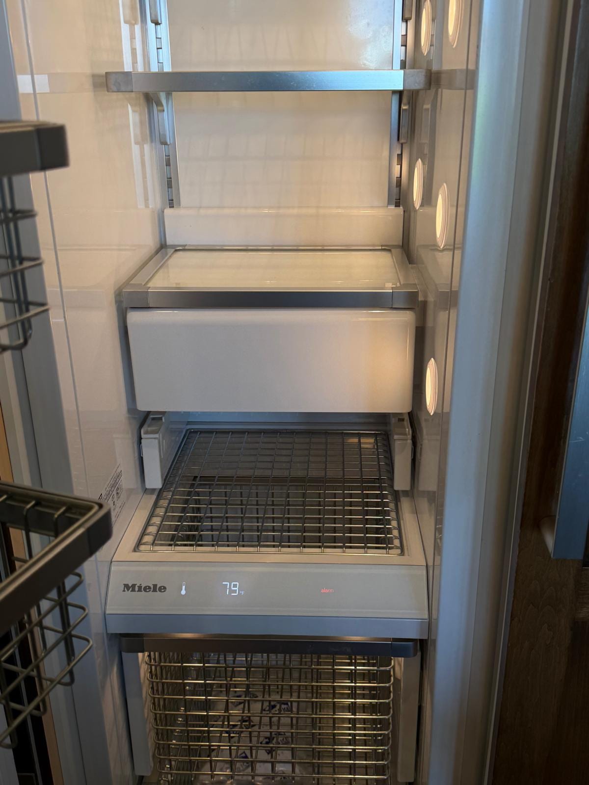 Open Miele freezer with its display reading 79°F and a red alarm indicator, in a Corona del Mar kitchen