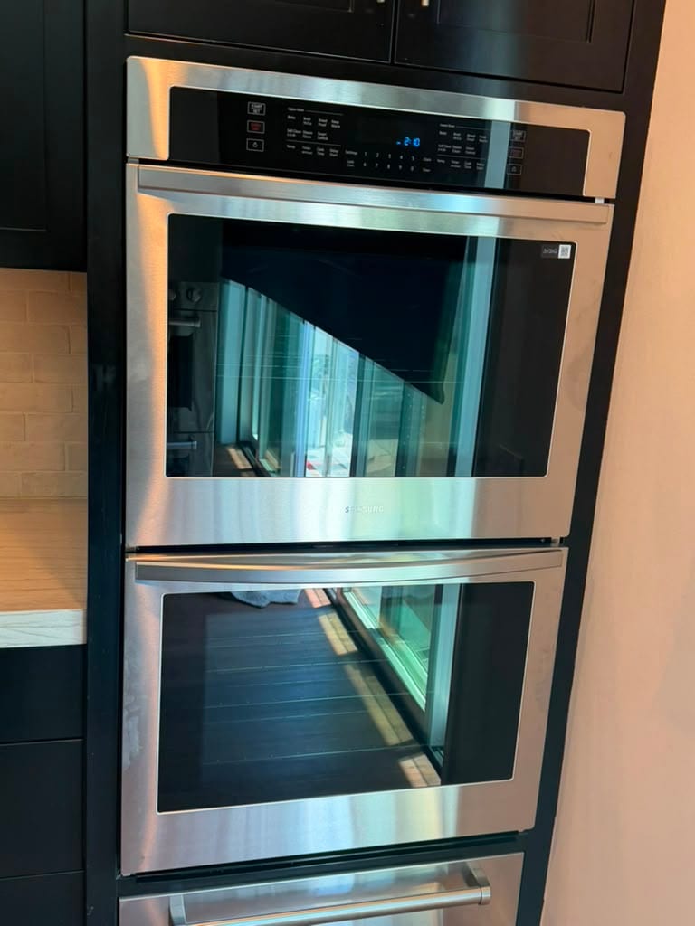 Newly installed Samsung stainless built-in double wall oven in a Newport Beach kitchen
