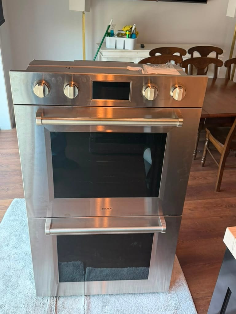 Wolf stainless built-in double wall oven removed from its cabinet opening during a Newport Beach service call