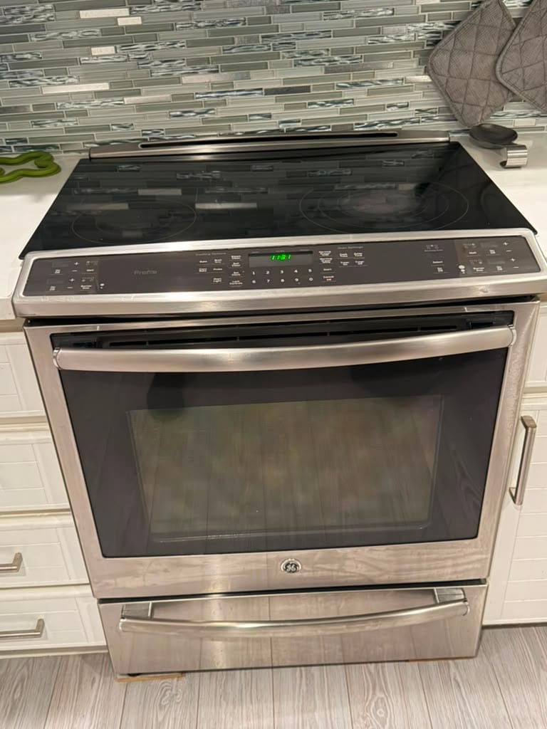 GE Profile stainless slide-in electric range after a control board replacement in an Irvine kitchen
