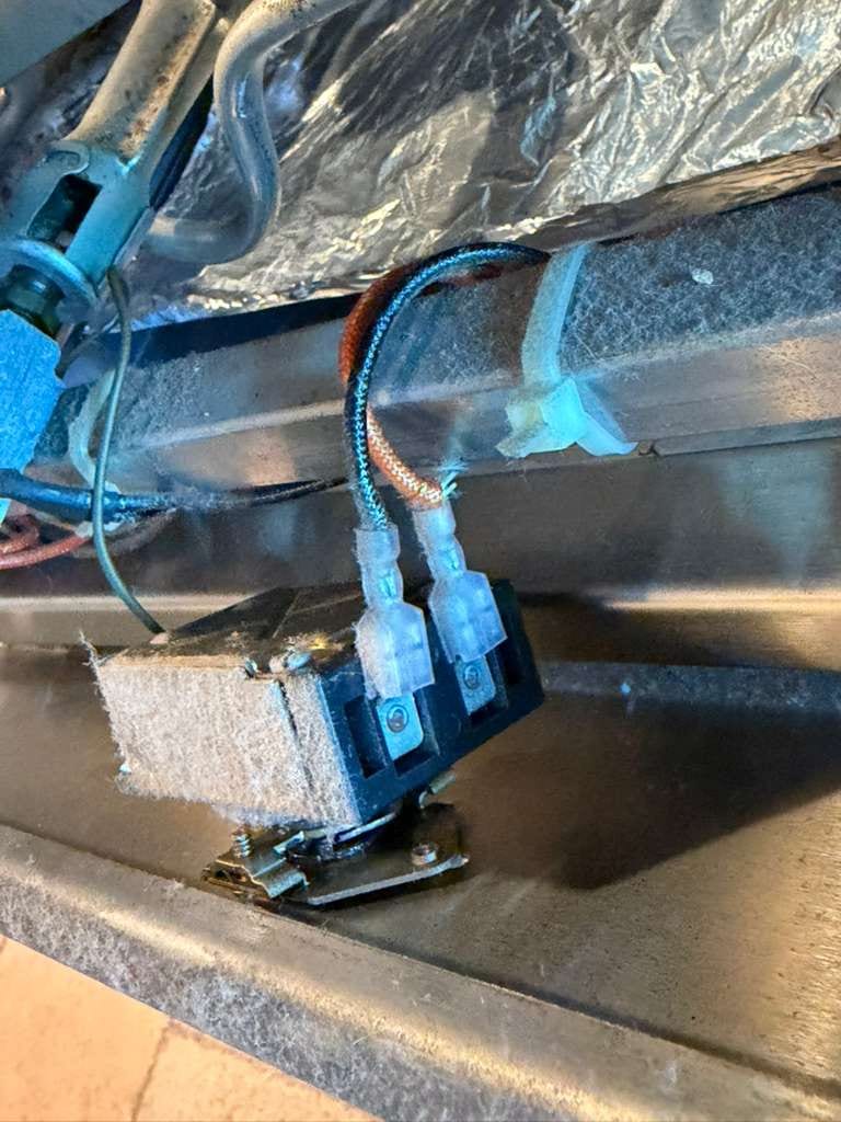 Close-up of the replacement gas oven thermostat and safety valve on a Viking range during a Mission Viejo service call