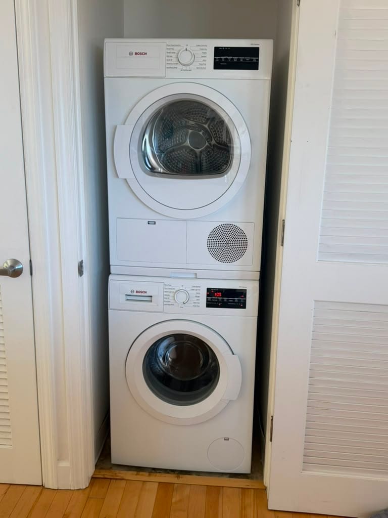 Stacked Bosch washer and dryer in a Laguna Beach laundry closet after a washer drain pump replacement