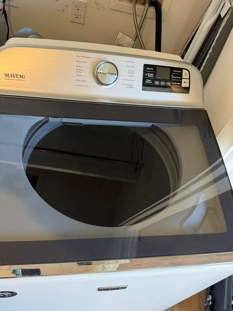 White Maytag Commercial Technology top-load washer with the lid open in a Corona del Mar laundry alcove during a control-board service call