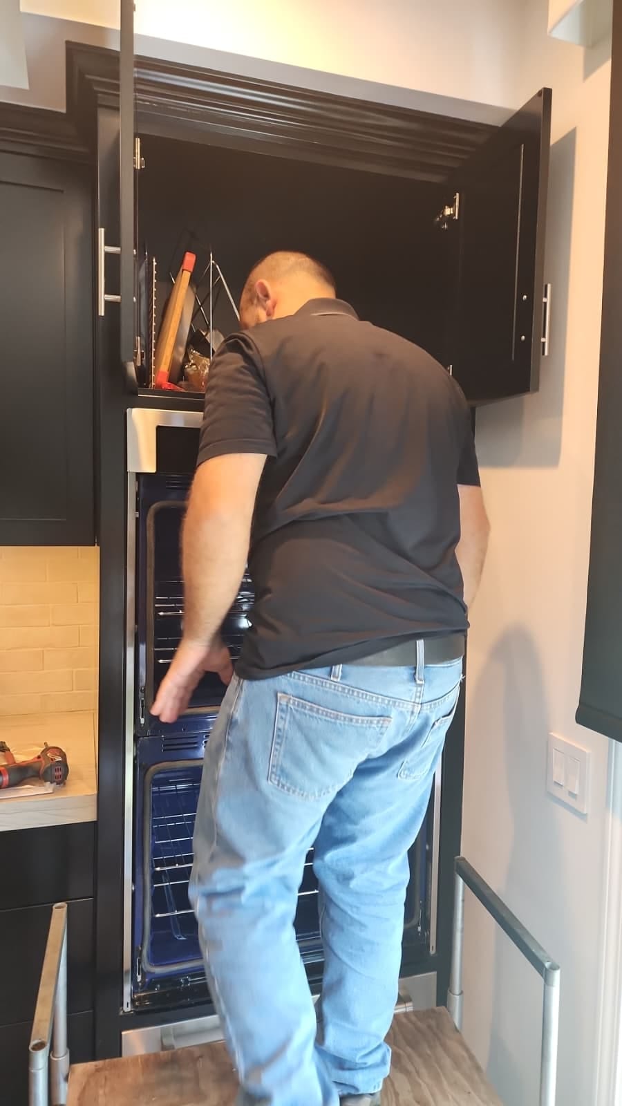 Universal Appliances Repair technician installing a Samsung built-in double wall oven in Newport Beach