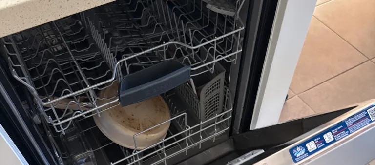 Photo from Chinese Student Association's review showing the open Bosch dishwasher we repaired