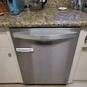 Stainless built-in dishwasher under granite countertop