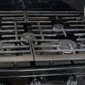 Photo from Marie Bennett's review showing the black gas cooktop that was repaired