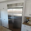 Photo from William Nugent's review showing his stainless steel built-in refrigerator in a white kitchen